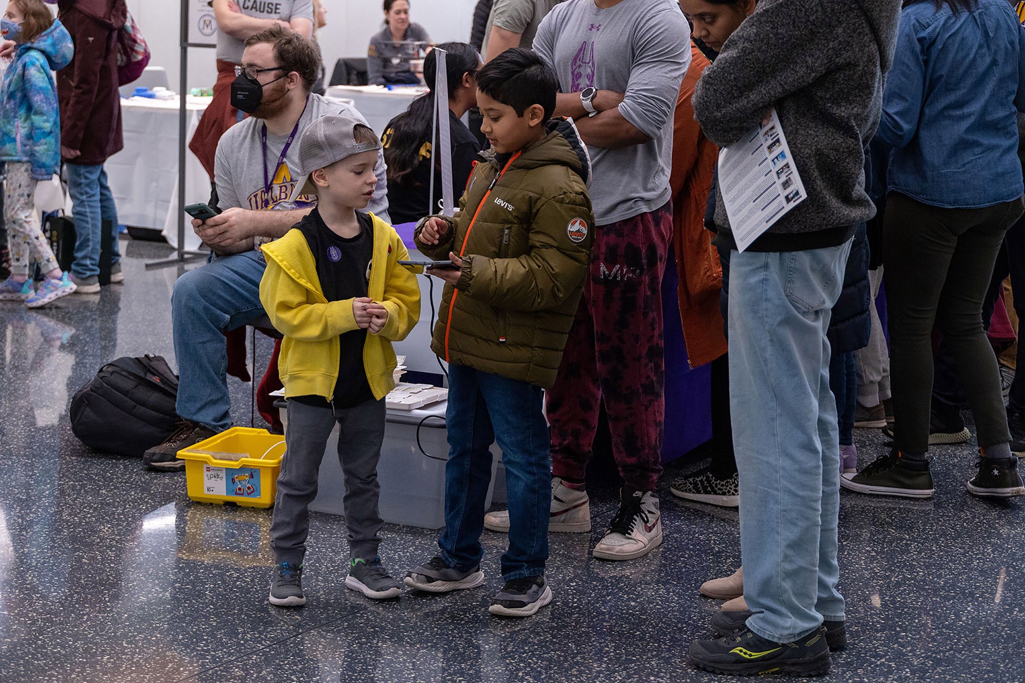 Two young boys play with robots at UAlbany's STEM & Nanotechnology Family Day at ETEC.