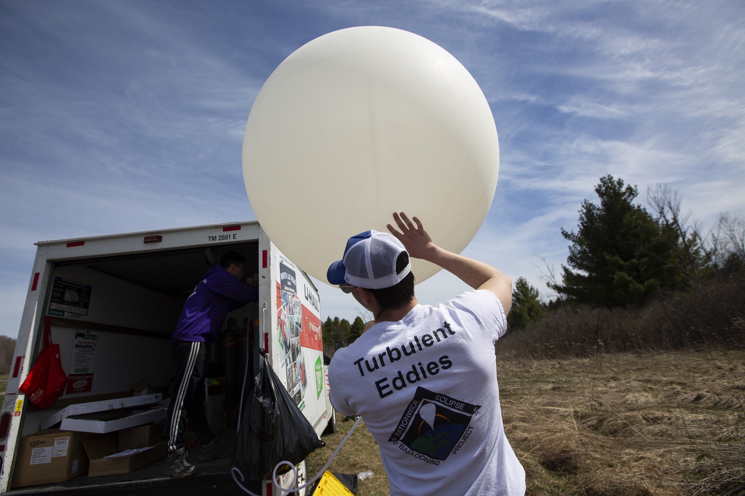 UAlbany senior David Zywiczynski prepares a weather balloon for launch at Fort Drum.