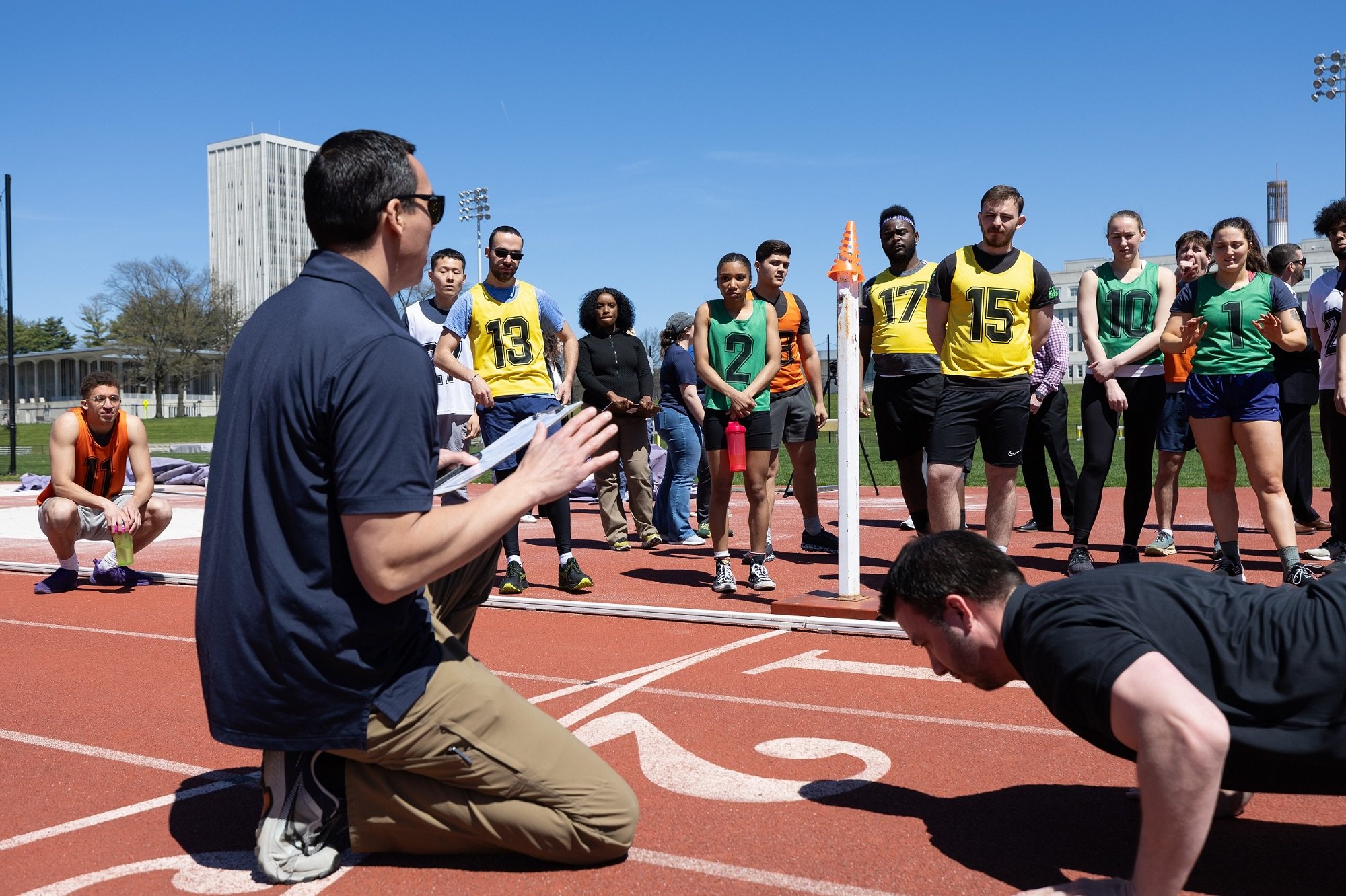A member of the FBI Albany Field Office talks with students before the start of the physical fitness test at UAlbany.