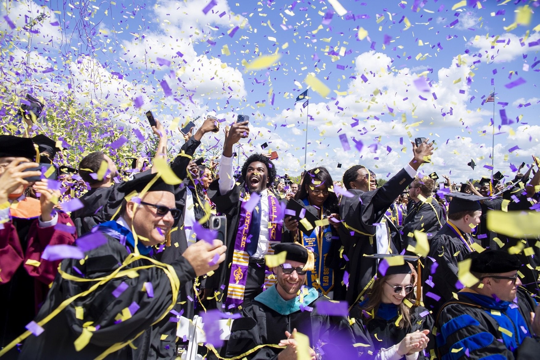 Purple and gold confetti rains down on students at the 2024 undergraduate commencement ceremony.