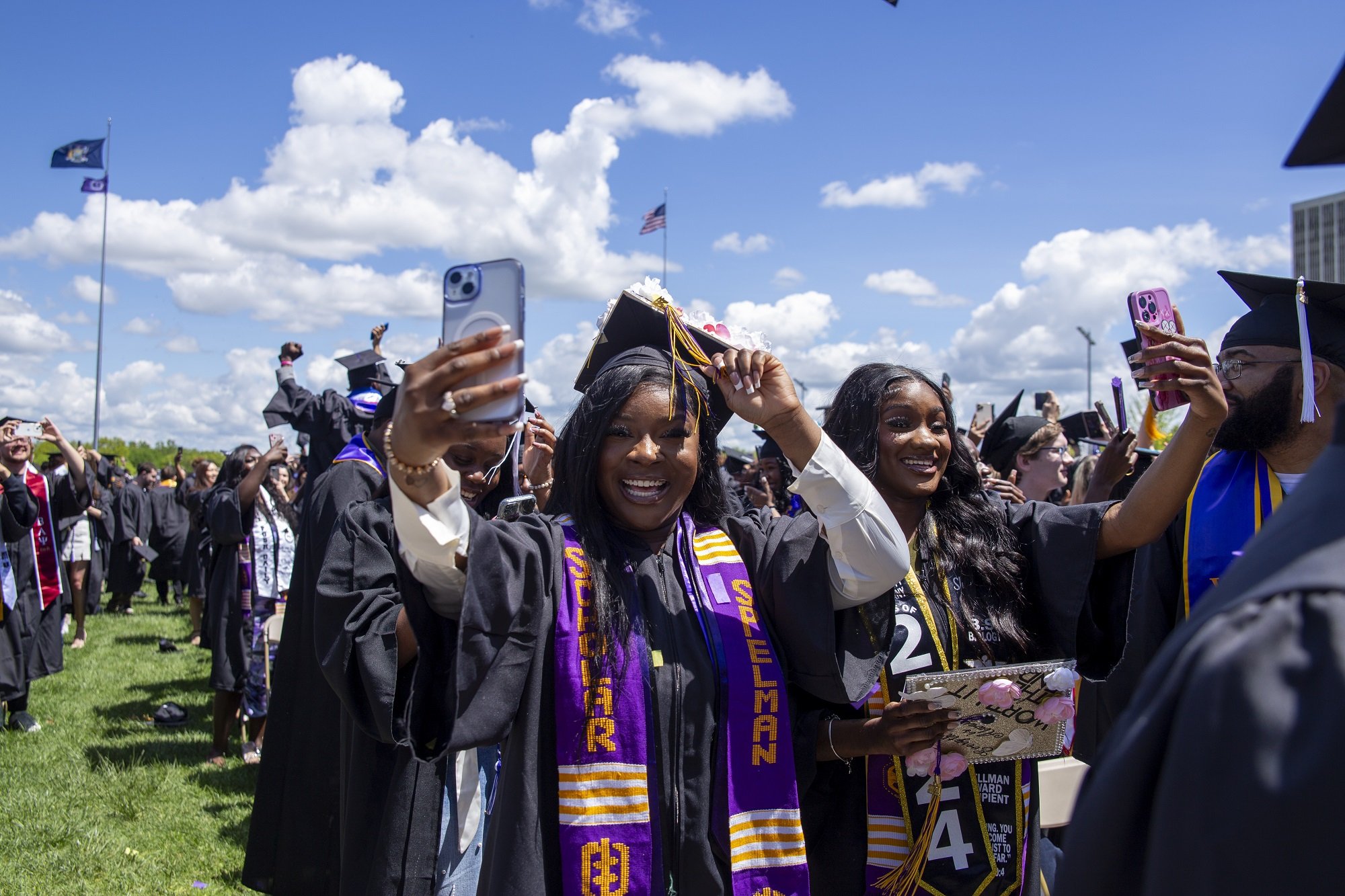 A UAlbany student takes a photo of the stage during the 2024 undergraduate commencement ceremony.