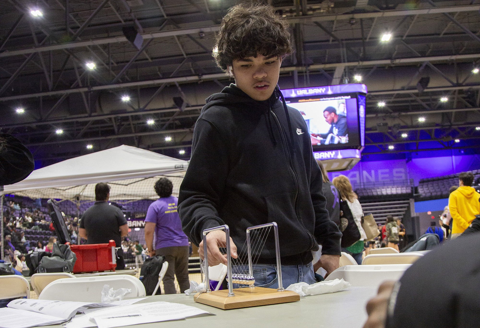 A middle school student plays with an engineering device during Showcase Day 2024 at Broadview Center.
