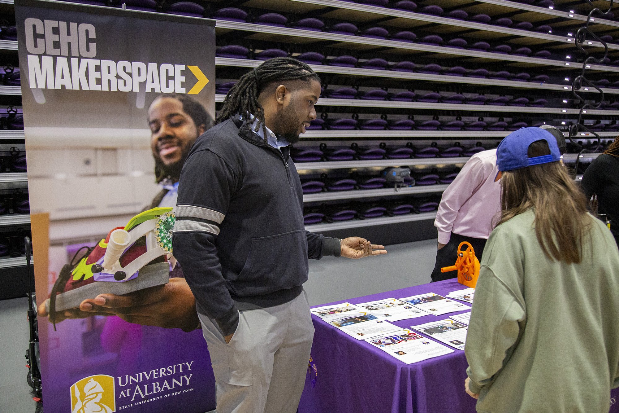 A UAlbany student in the College of Emergency Preparedness, Homeland Security and Cybersecurity presents during Showcase Day at Broadview Center.