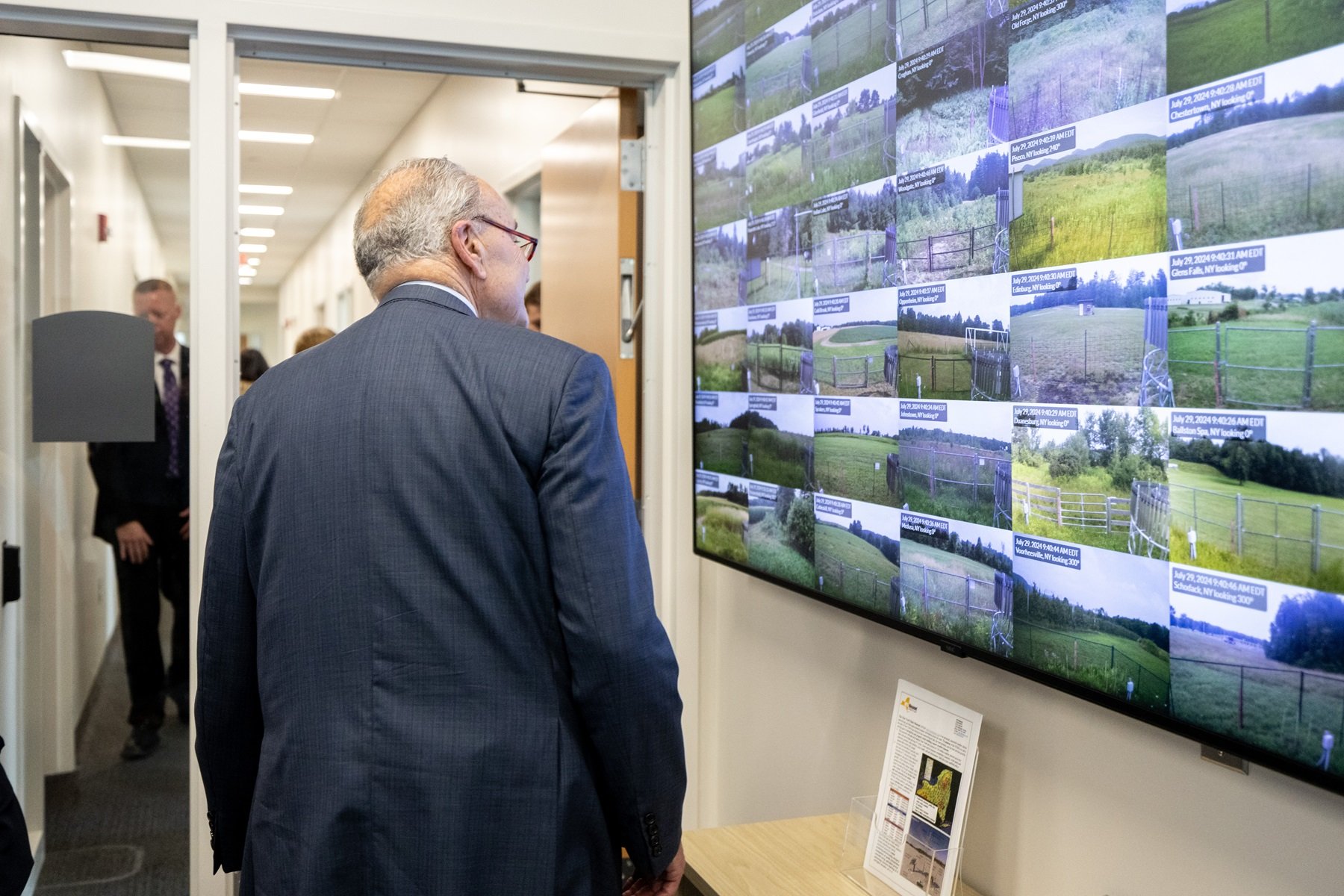 Senator Schumer views a screen of camera images at network site locations inside the NYS Mesonet operations center.
