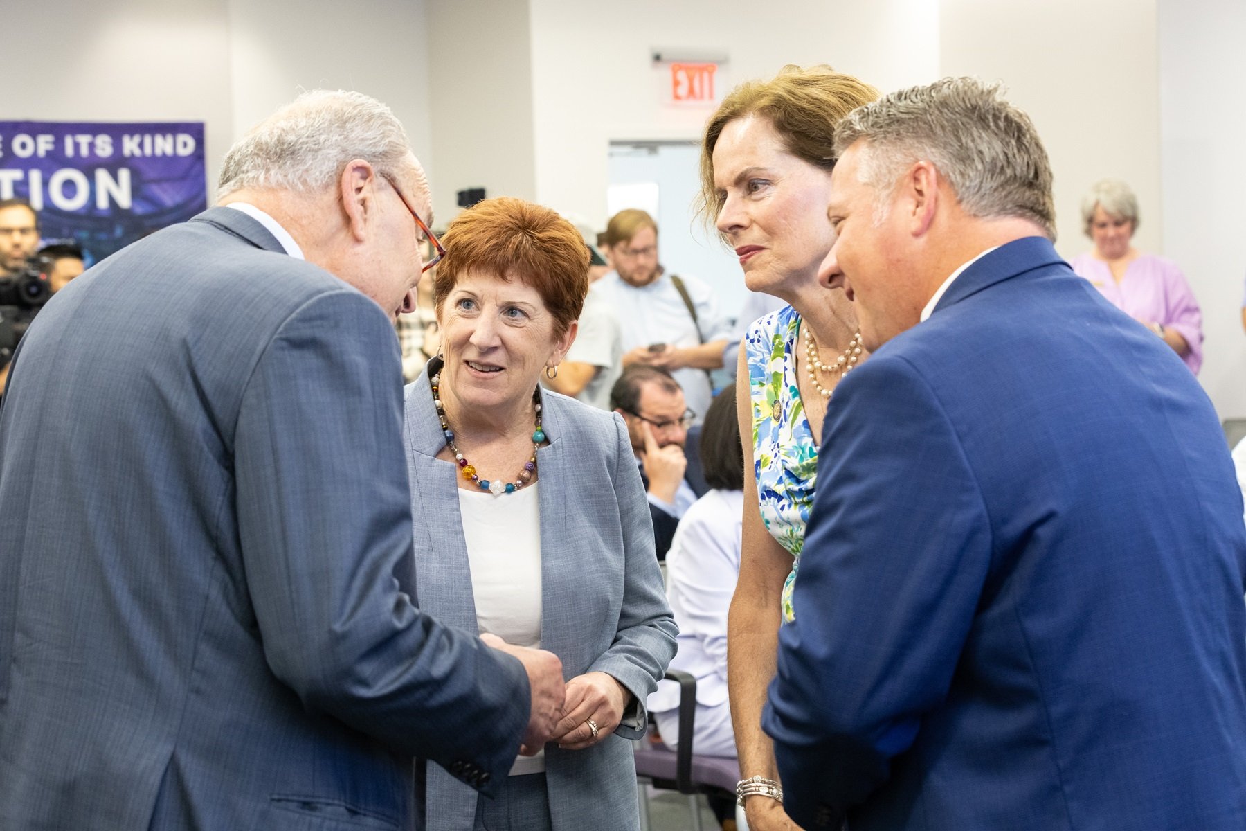 Senator Schumer shakes hands with local elected officials before press conference at ETEC.