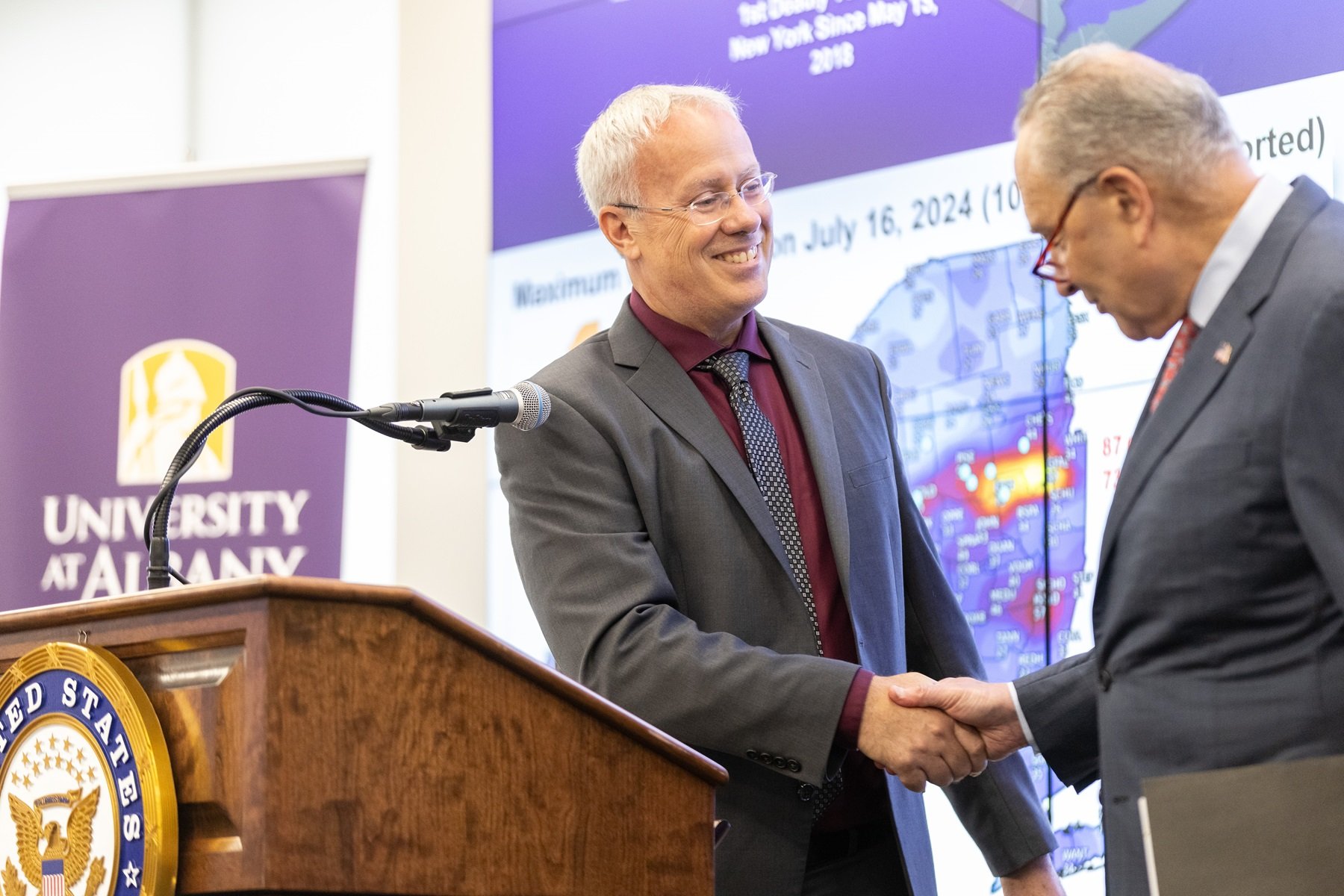 NYS Mesonet Executive Director Chris Thorncroft shakes hands with Senator Schumer during a press conference at ETEC. 