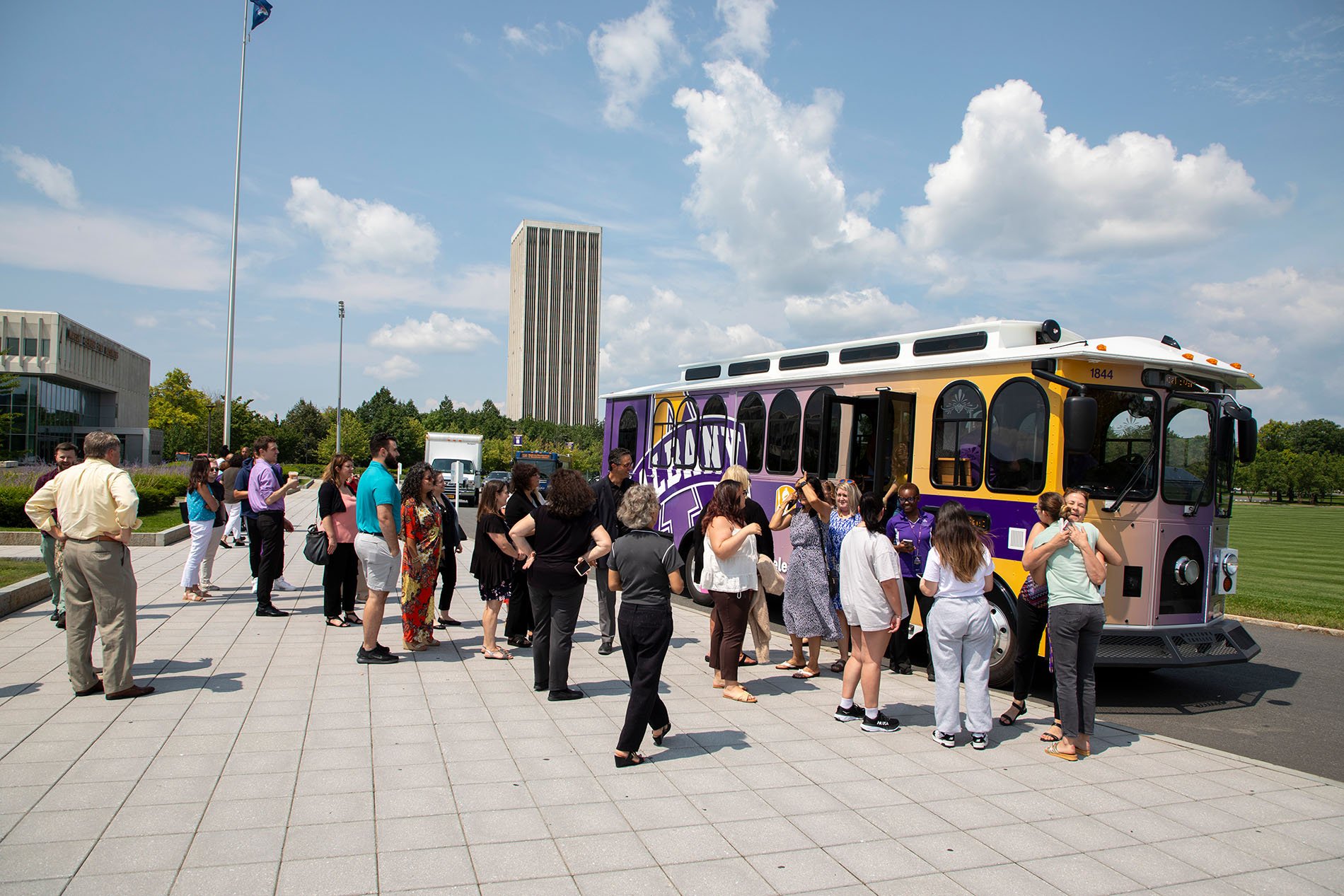 A group of people waiting to get on the trolley