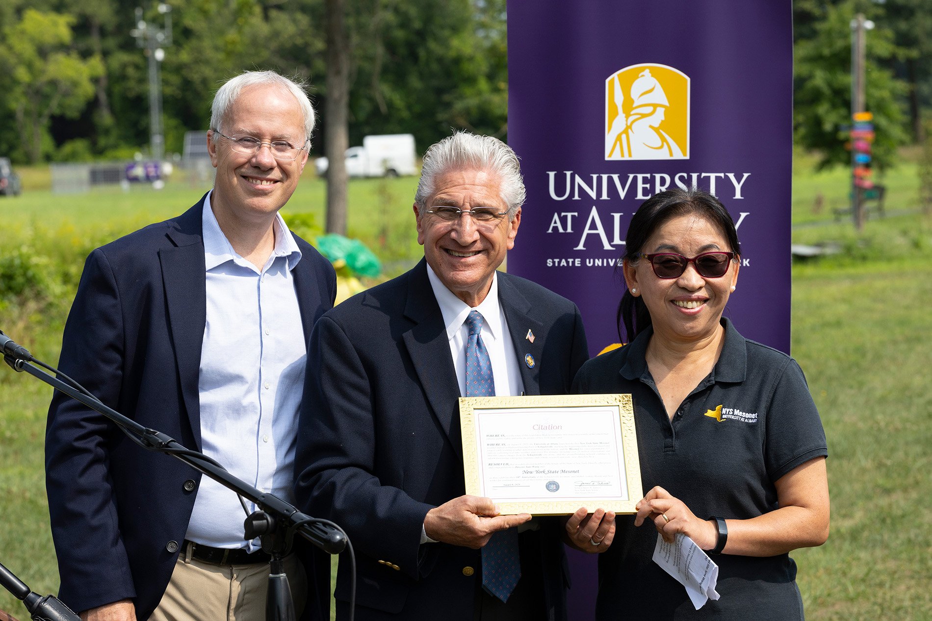 Sen. Jim Tedisco offers a proclamation to Mesonet leaders Chris Thorncroft and June Wang.
