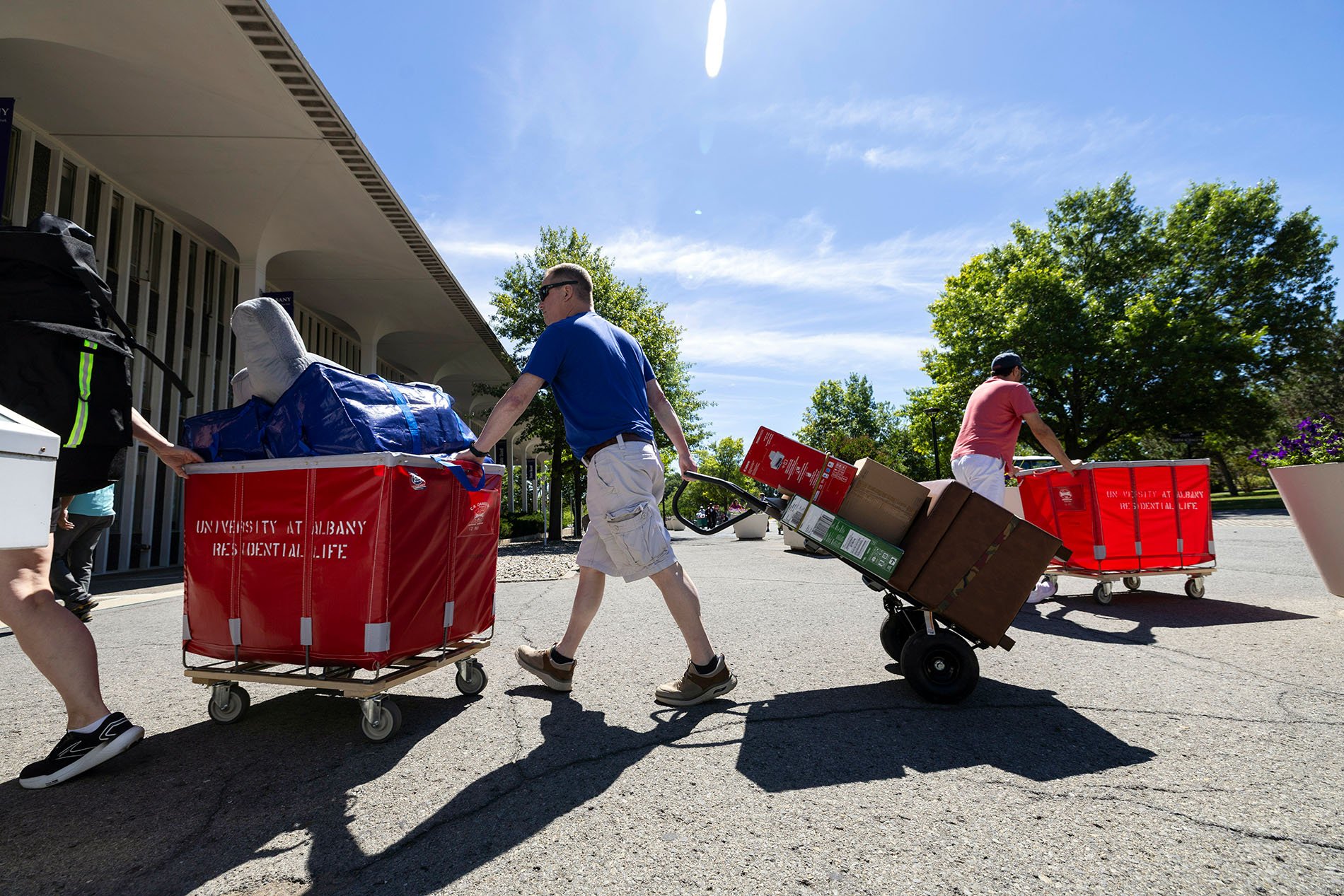 Students and families using moving bins  
