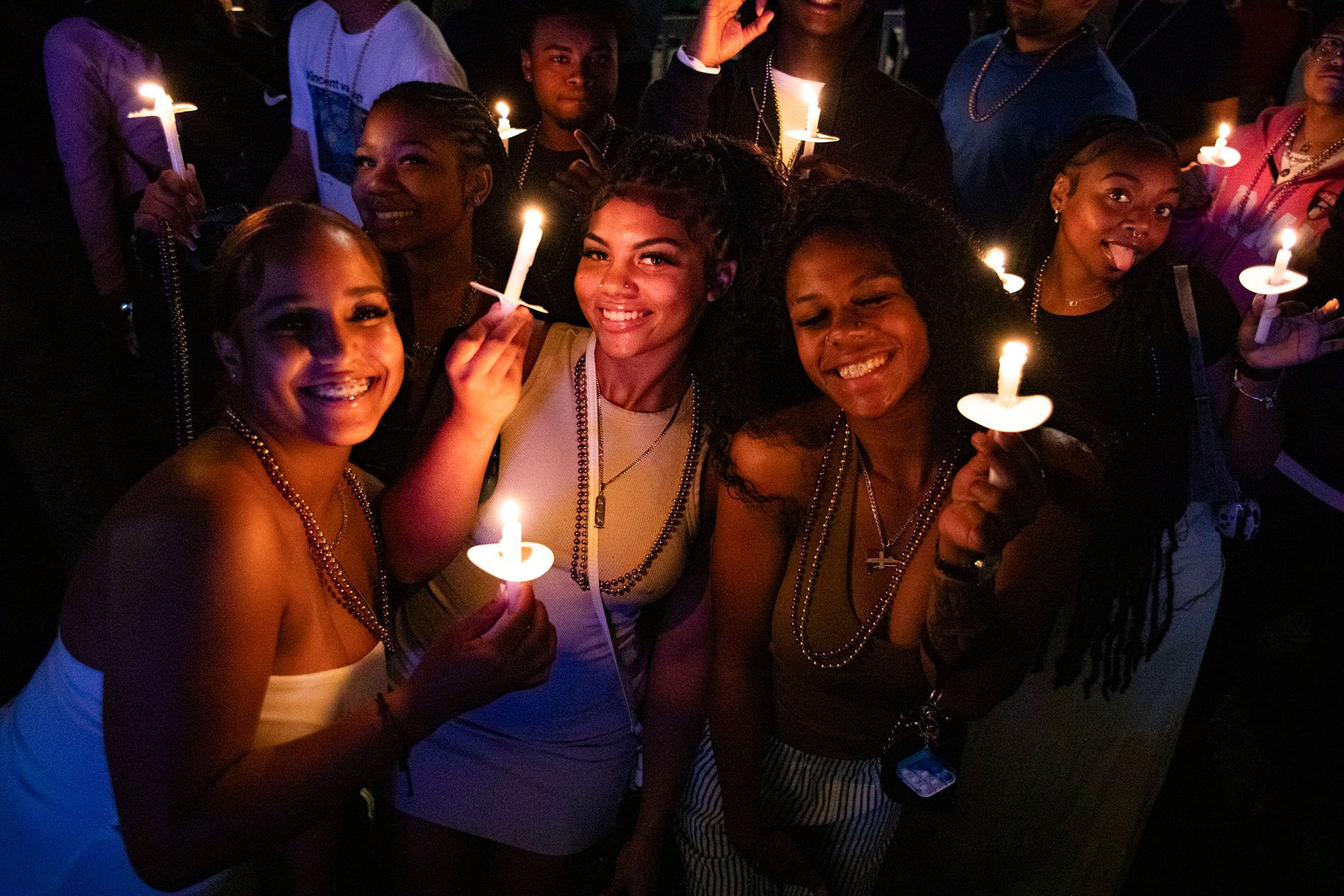 Students attending convocation by candlelight