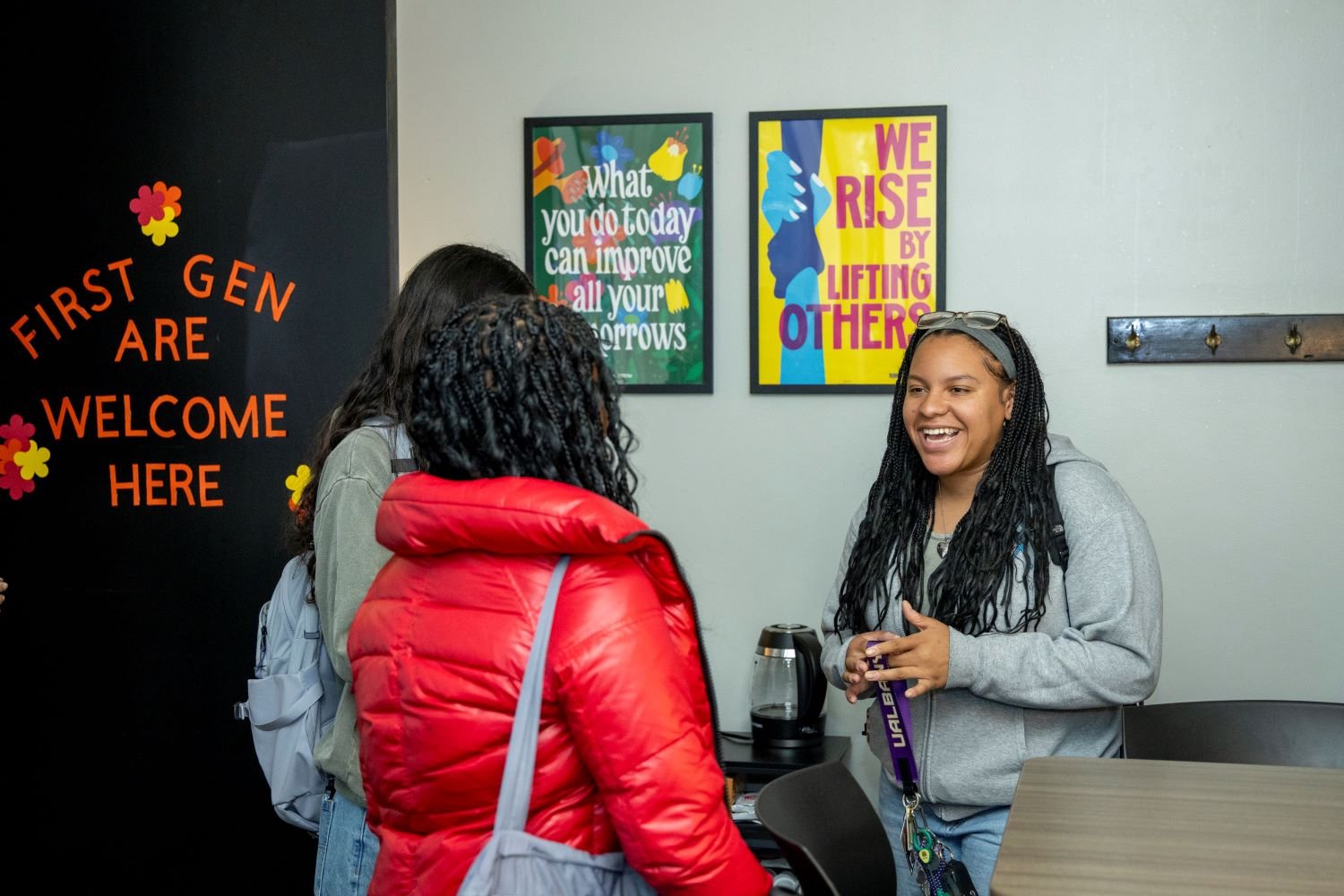 three students talk in the new lounge