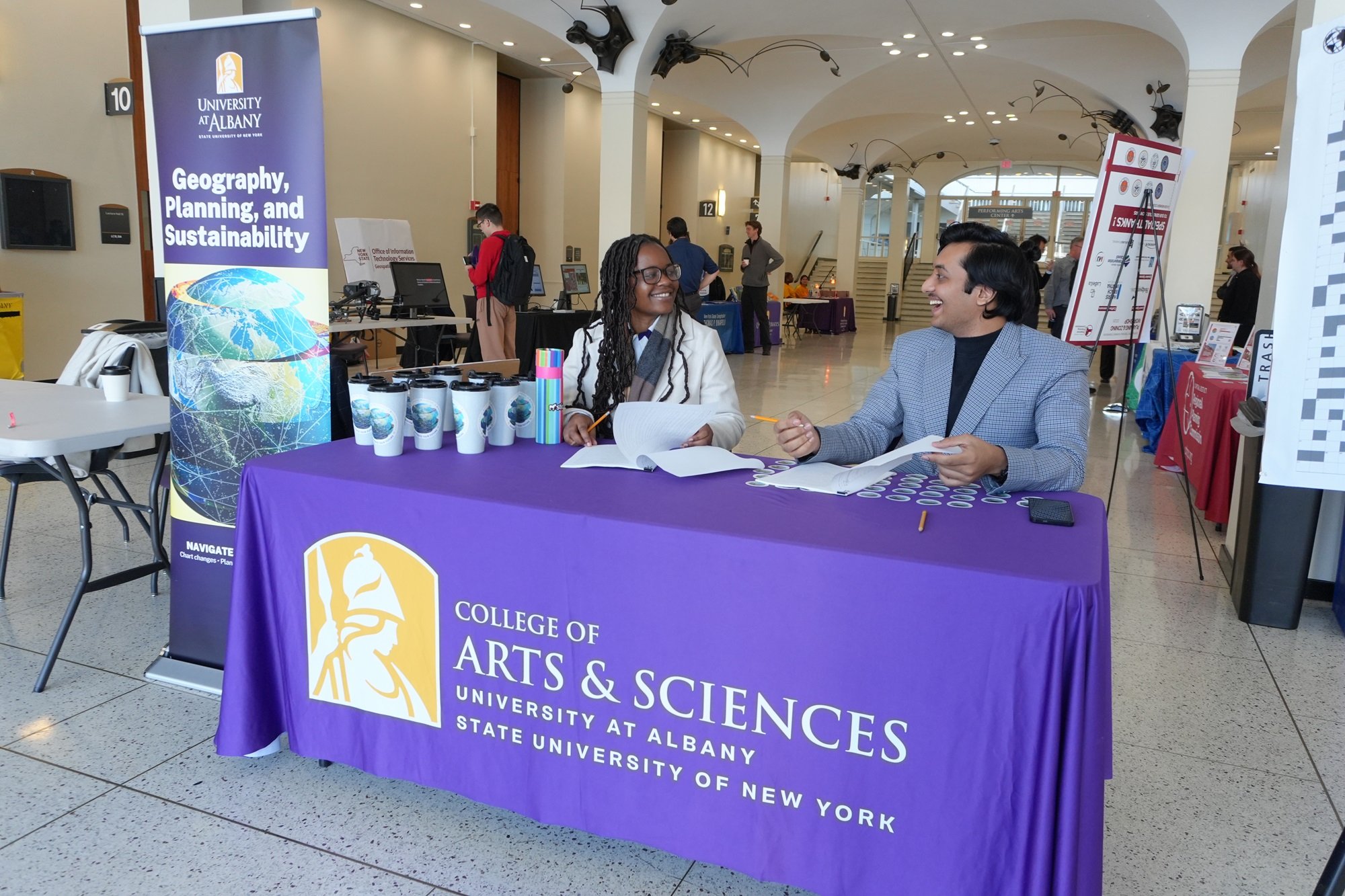 Students check in people at UAlbany's GIS Day celebration.