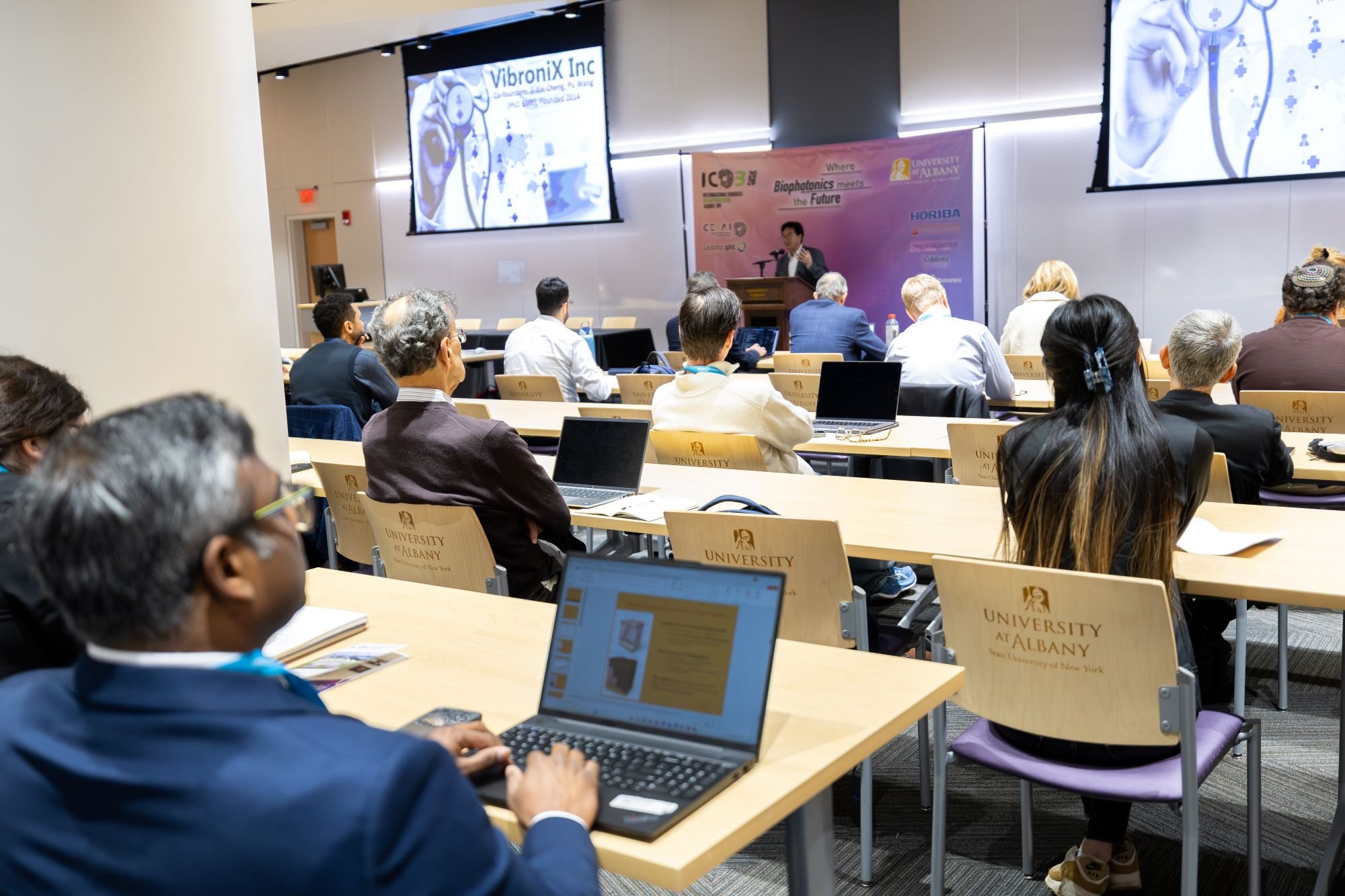 Attendees view a presentation from ETEC's Shared Training Room during the International Congress on Biophotonics.