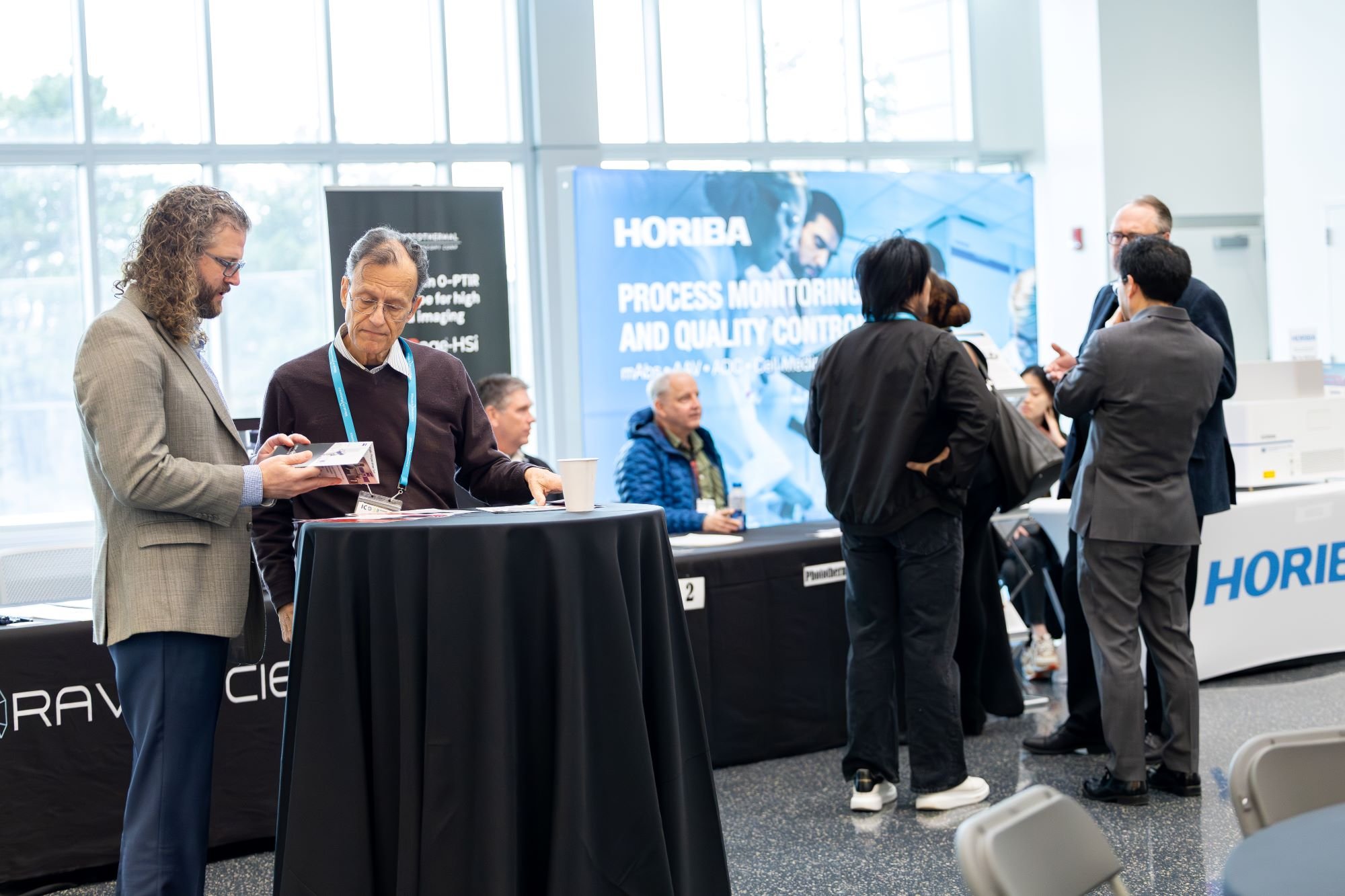 Attendees network in the ETEC lobby between sessions during the International Congress on Biophotonics.