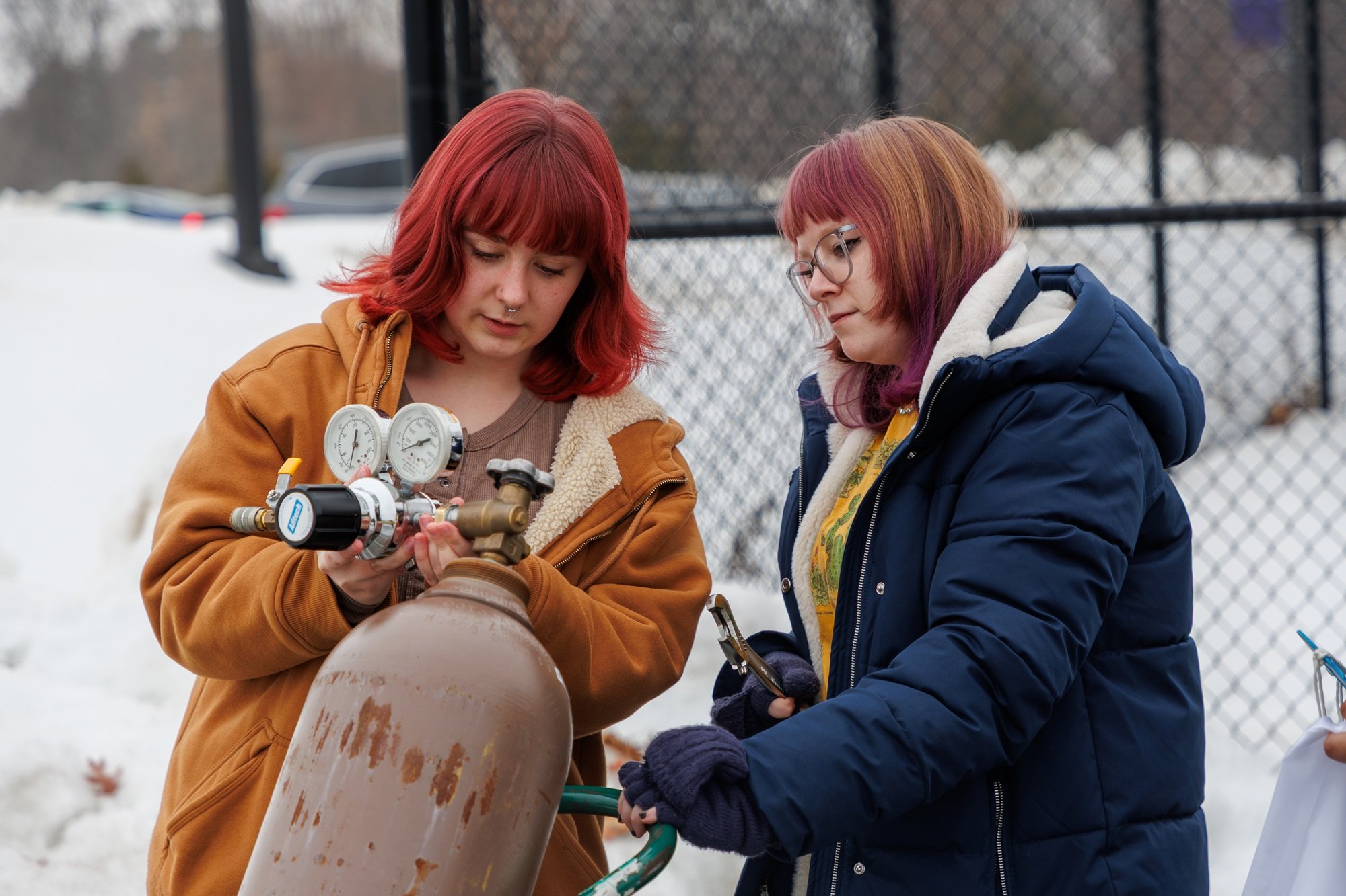 UAlbany students roll out a helium tank used to fill up a weather balloon before launch.
