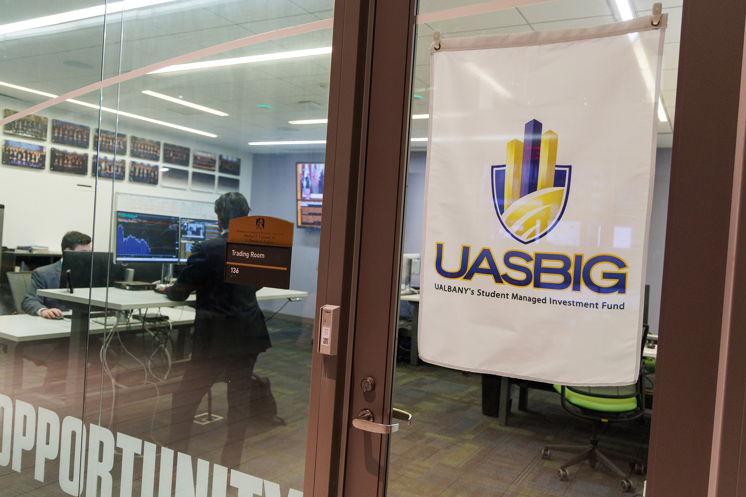 A sign outside of the Bloomberg room at UAlbany's Massry School of Business reads UASBIG for the student investment group.