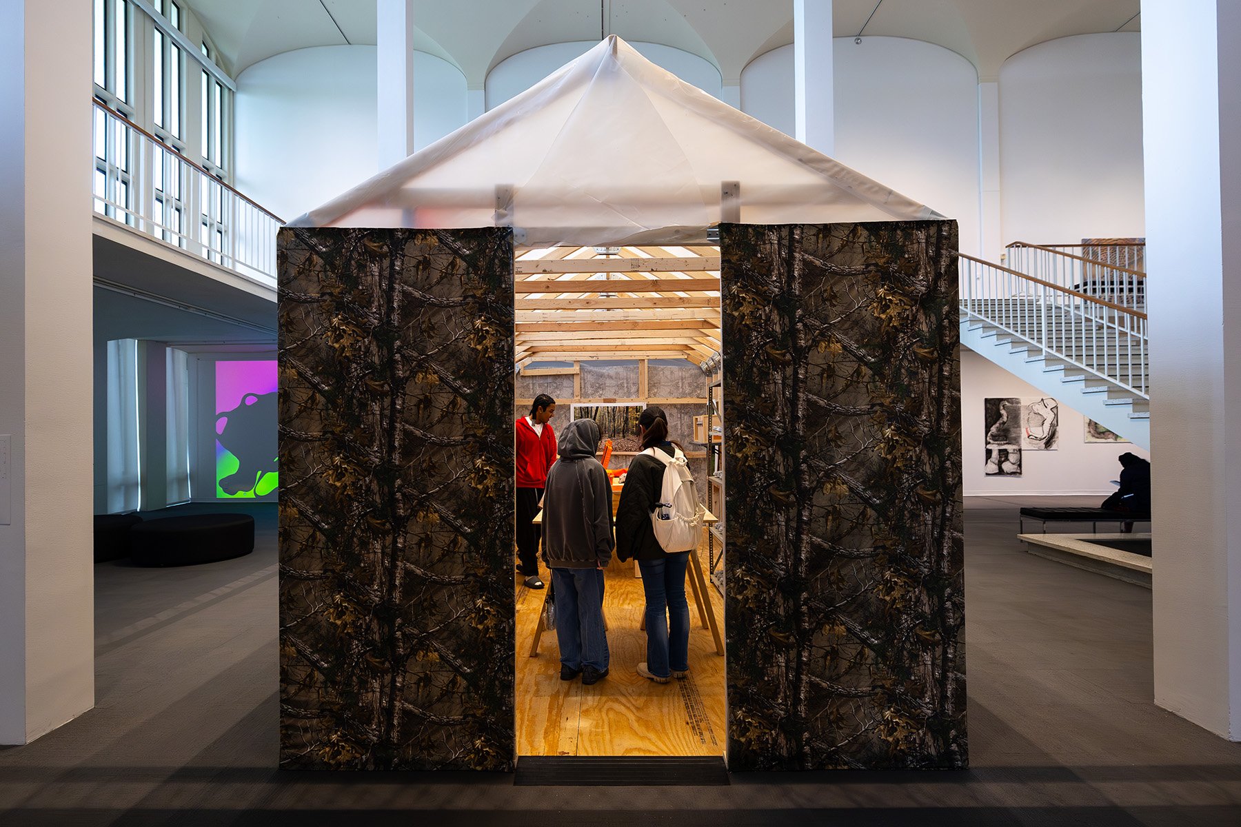 Visitors in a cabin structure within the museum