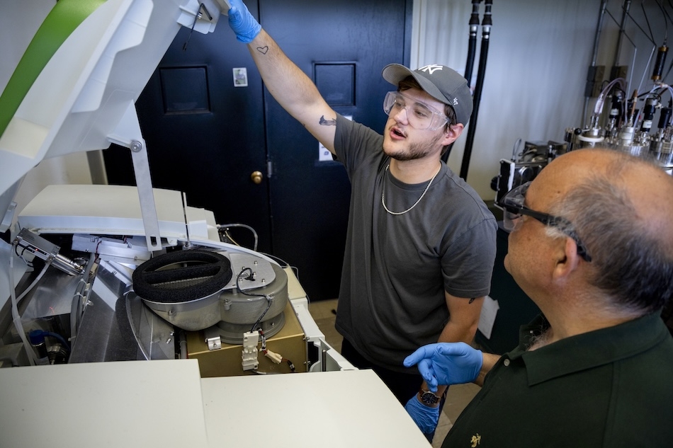 People in safety glasses gather in a laboratory for a training on energy storage technologies
