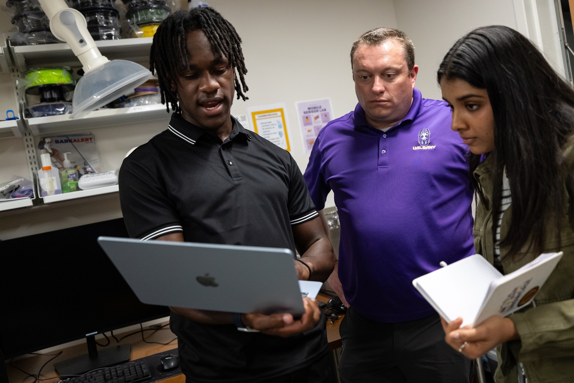 Eric Best of UAlbany's Department of Emergency Management and Homeland Security reviews a presentation with students.
