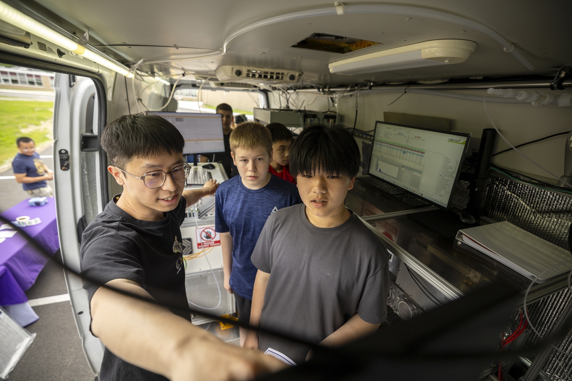 Students from Lisha Kill middle school look at instrumentation inside ASRC's mobile lab. 