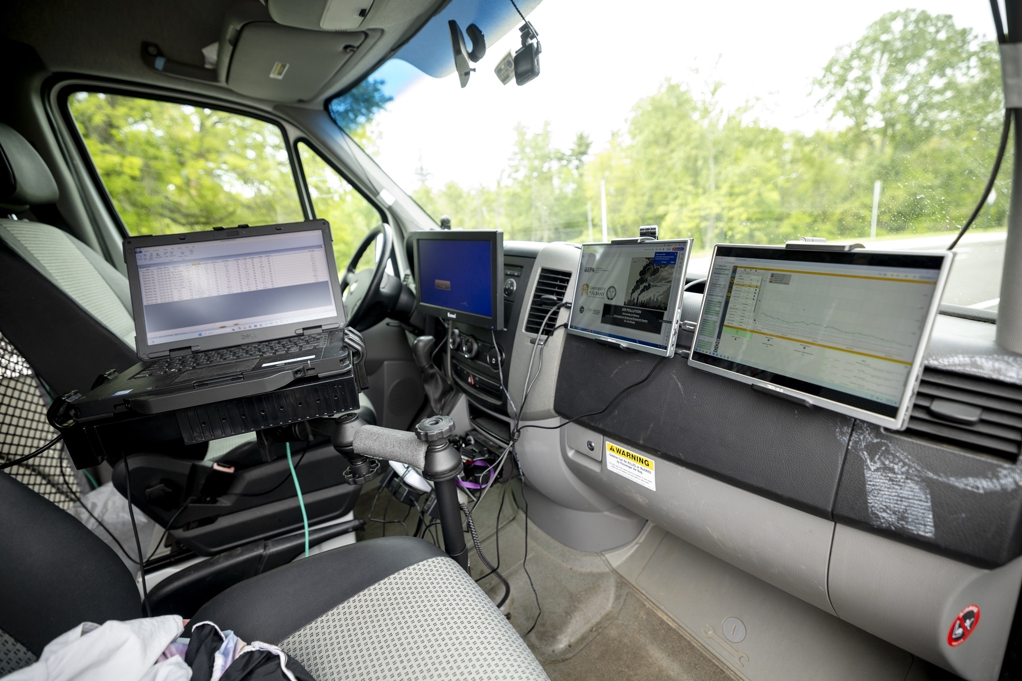 Instrumentation including a laptop with real time air quality measurements is seen inside ASRC's mobile lab.