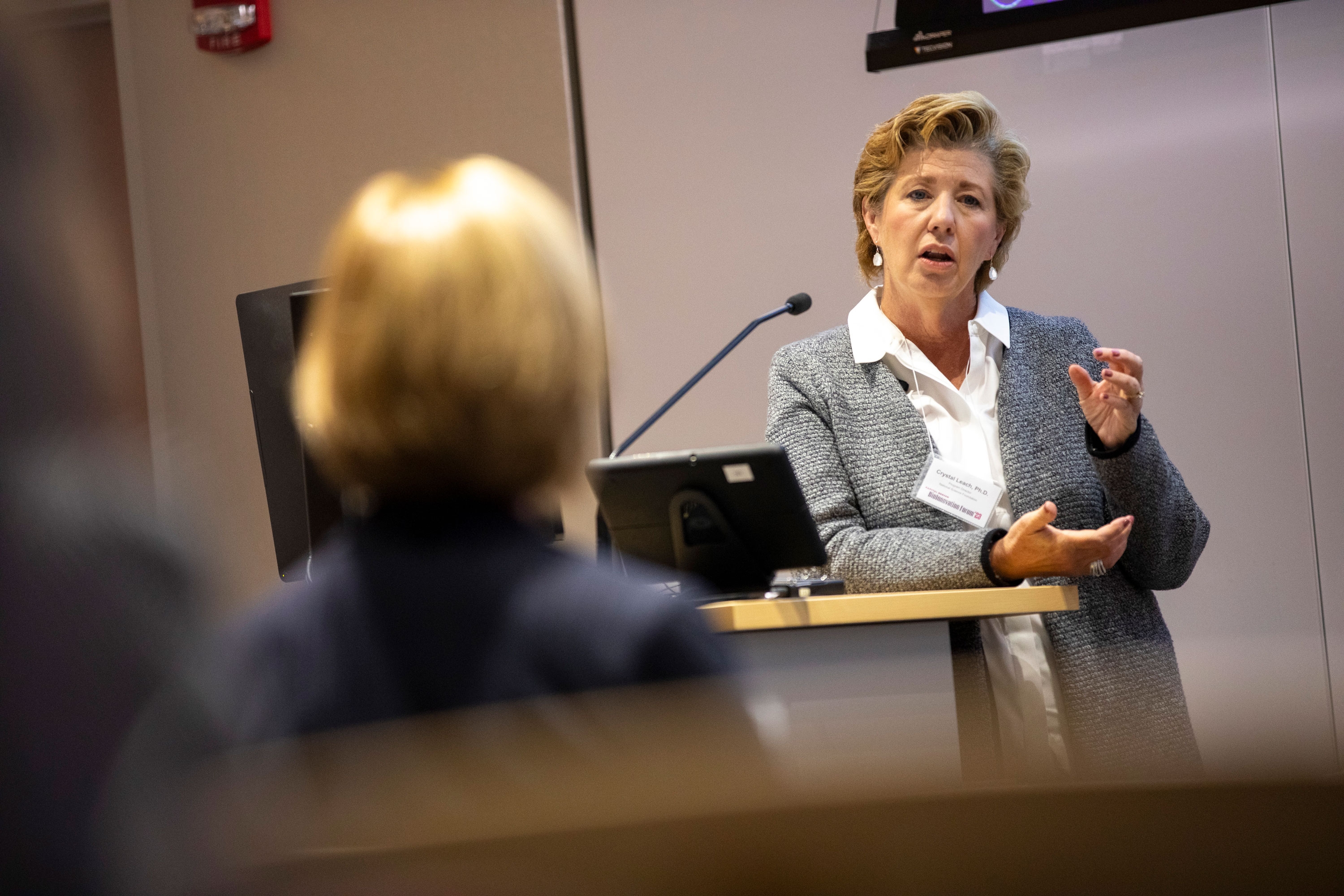 A researcher gestures as she speaks to an audience at R&E Week 2023.