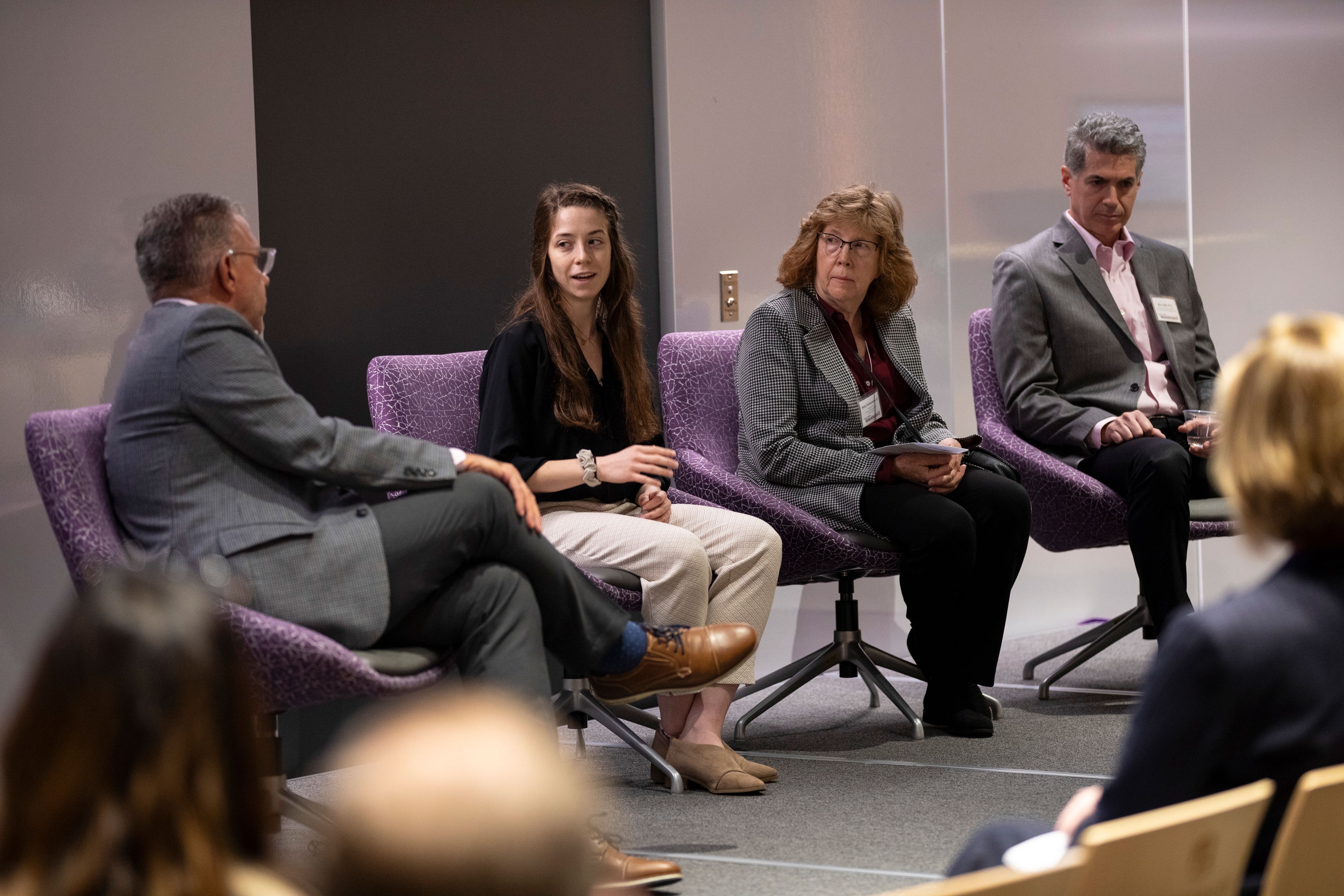 Four researchers sit on stage and participate in a panel discussion during R&E Week 2023.