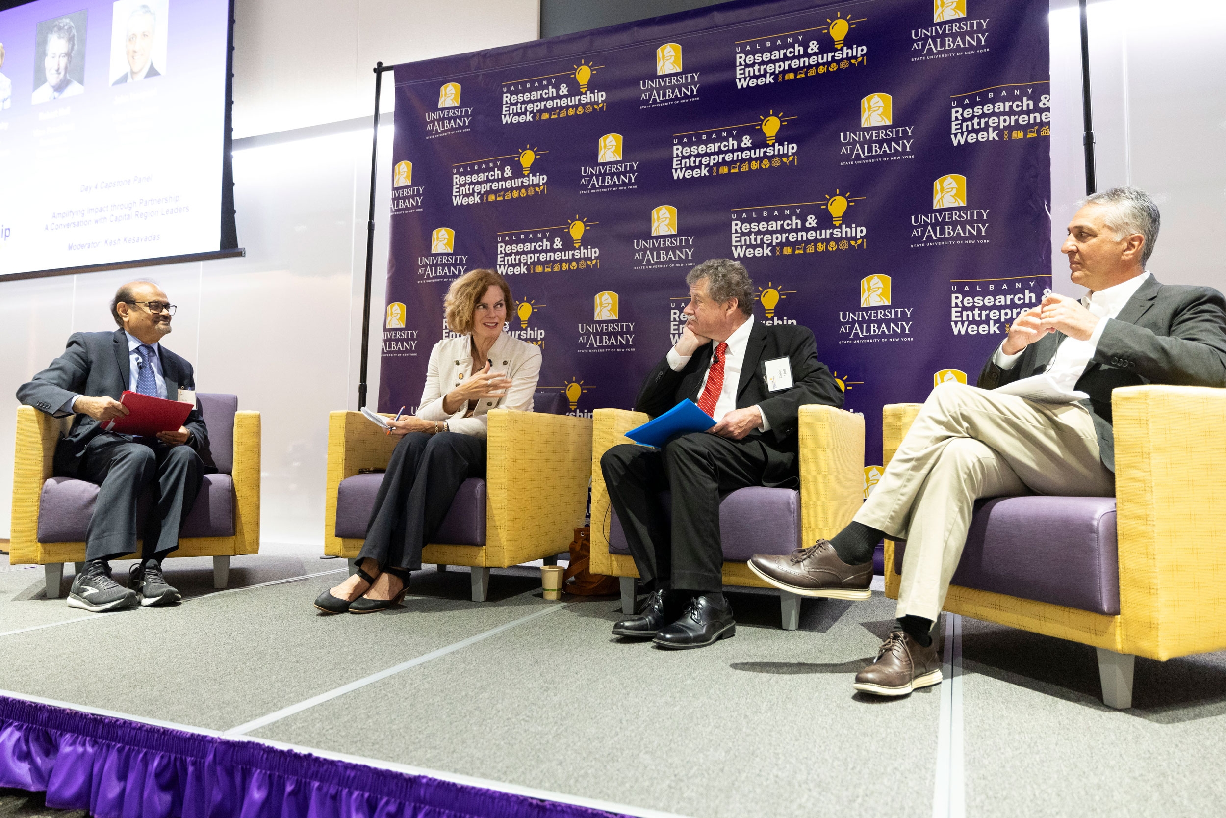 New York State Senator Pat Fahy gestures while speaking with other panel members on stage at R&E Week 2024.