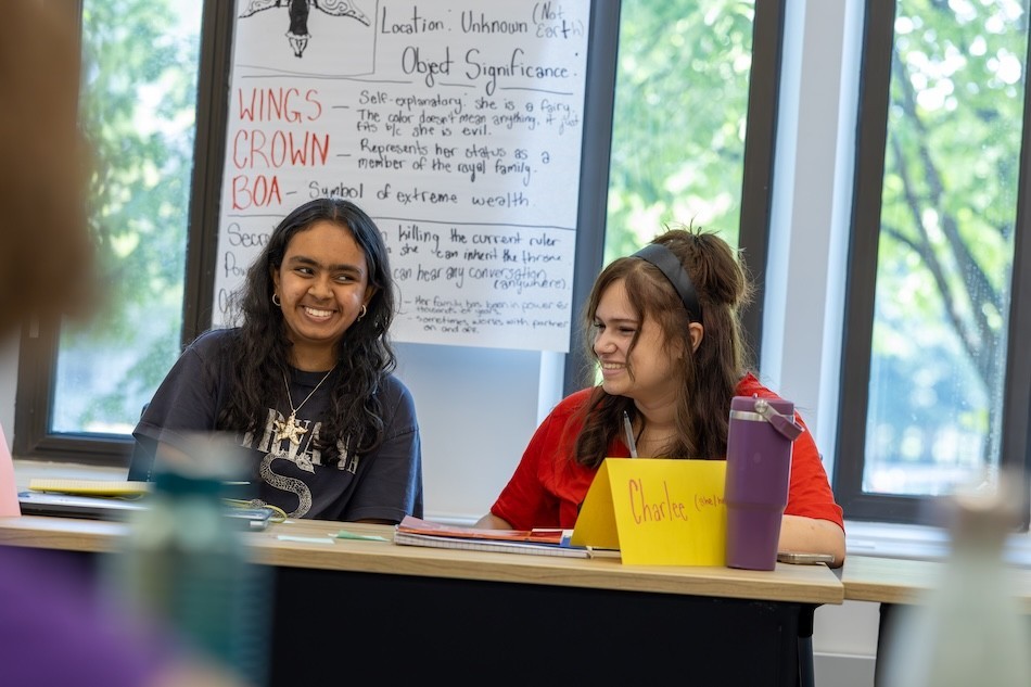 Teen girls laugh at a creative writing workshop