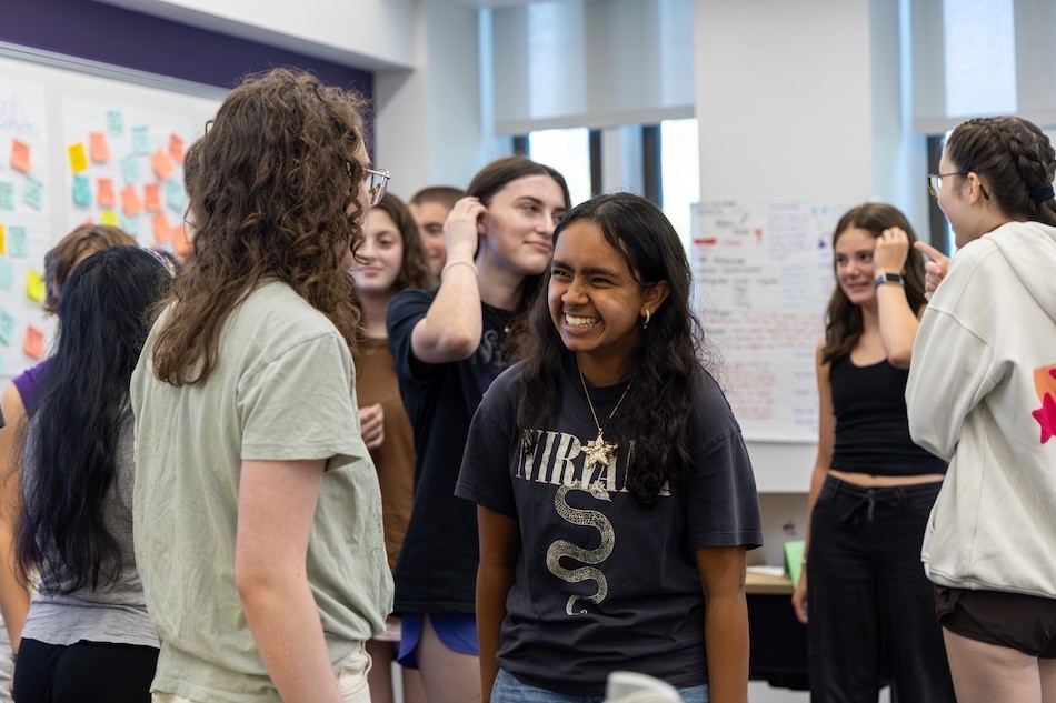 Teens laugh and smile as they participate in a creative writing workshop