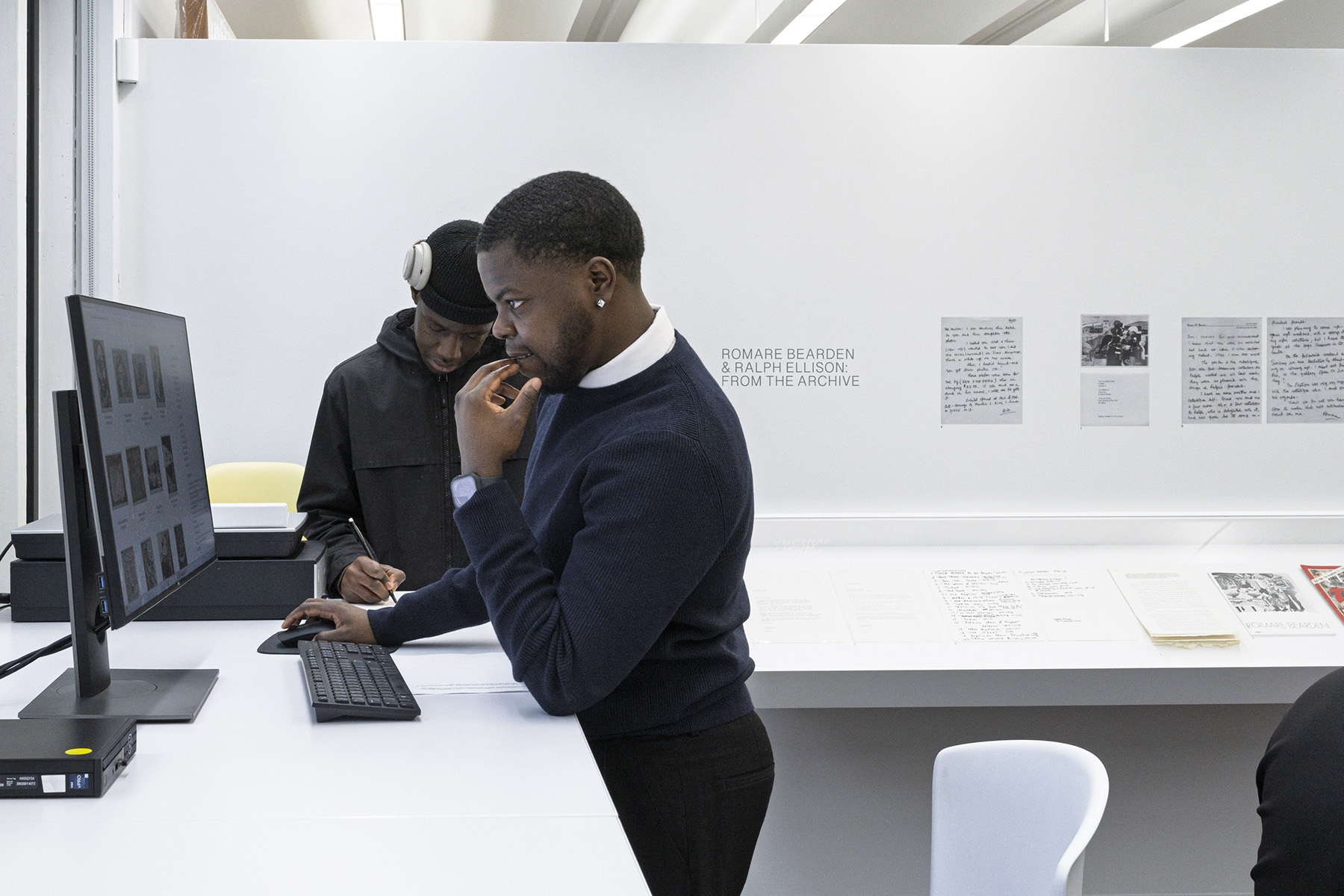 Two students using a computer at a standing desk