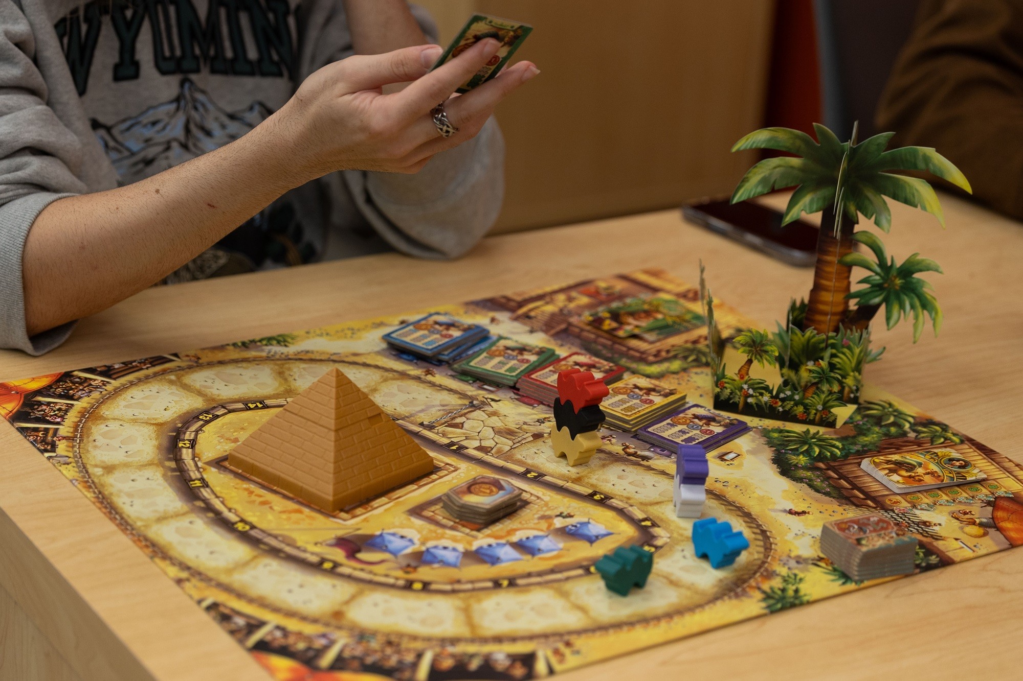 A board game is shown inside the Game Hub.