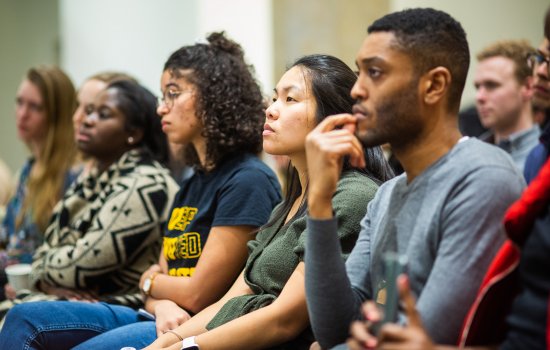 Graduate students several races sit in class in concentration