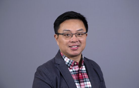 Dr. Qian smiles at the camera.