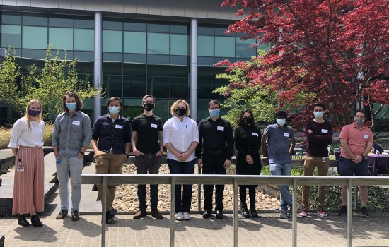 10 young students stand behind a hitching post in the Life Sciences Research Building courtyard