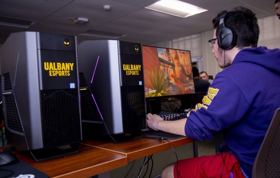Photo of a UAlbany eSports student in the competitive gaming arena at Draper Hall.