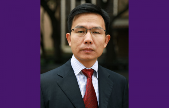 Kai Zhang smiles at the camera.