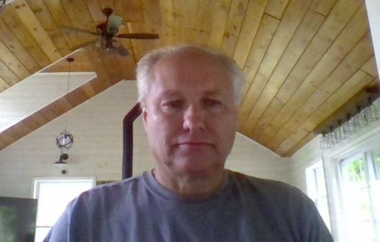 Lloyd Wilson, at his home, smiles at the camera.