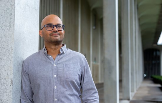 Jason D'Cruz leans against a concrete pillar on the Podium