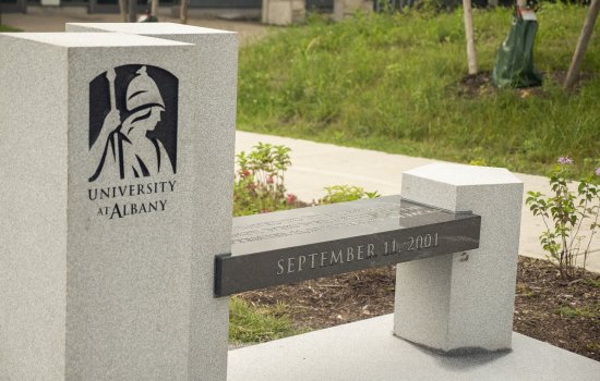 Image of UAlbany's 9/11 memorial bench on the walking path to ETEC.