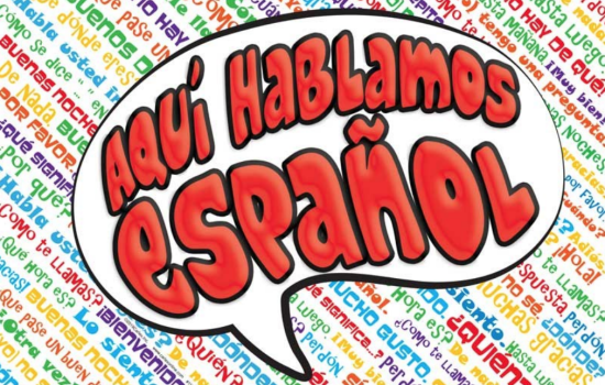 In large letters the words Aquí hablamos español float above a background of smaller Spanish words in many colors
