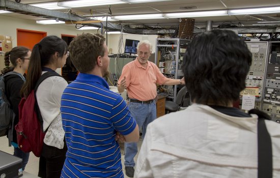 students listen to a presentation by Prof. William Lanford inside the Ion Beam Lab at UAlbany