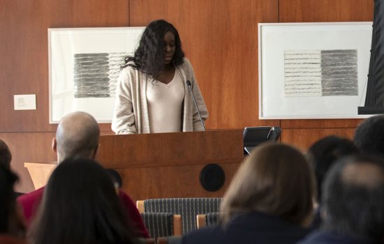 English Doctoral student Ola Kalu reads a Toni Morrison passage at the Toni Morrison tribute.