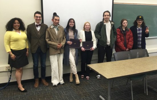 (Pictured, L to R: Jewls Douge, Erik T Jones, Linfeng Li, Jordan Castaldo, Paige Neal, Lakota Levandowski, Mairead Abbenda, Xavier Fitzsimmons Cruz)