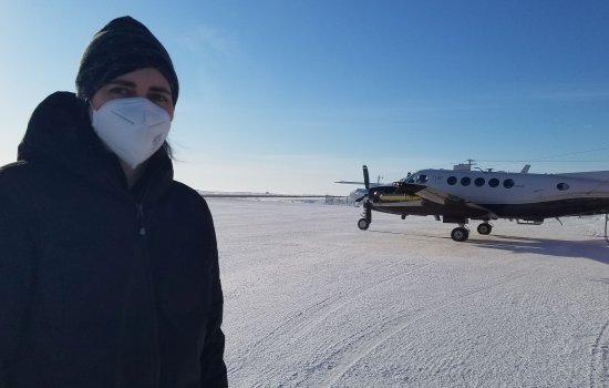 Sara Lance stands in front of research aircraft used during the airborne field campaign in the Arctic.