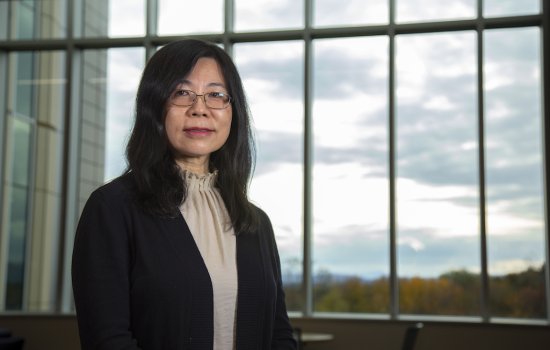 Dr. Yanna Liang, Department Chair of Environmental and Sustainable Engineering sits next to window