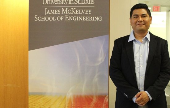 Daniel Moreno-Jimenez stands in front of University in St. Louis James McKelvey School of Engineering banner