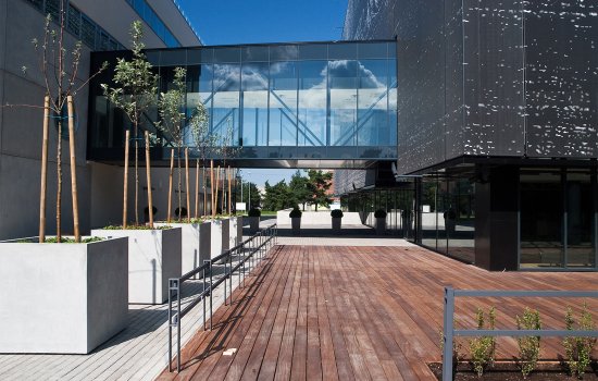 An elevated glass walkway between buildings at Tallinn University of Technology in Estonia.