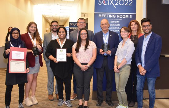 Lednev and two generations of his student researchers accept awards at the Great Scientific Exchange conference in Covington, Ky.