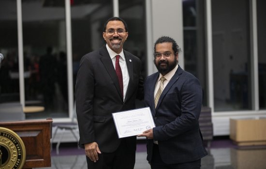 SUNY Chancellor John B. King Jr. presents Arshad Arjunan Nair with the Graduate Dissertation Award at ETEC.